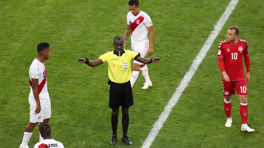 Referee Bakary Gassama calls for VAR (Video Assistant Referee) review 