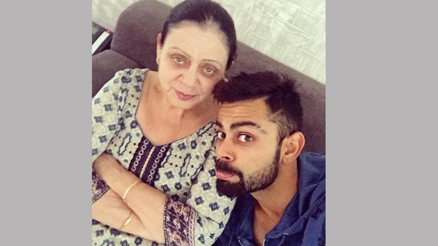 Virat Kohli with his mom.jpg