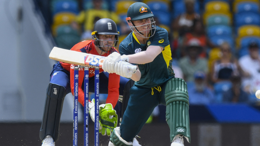 Australia's David Warner (R) hits as England's captain Jos Buttler (L) 
