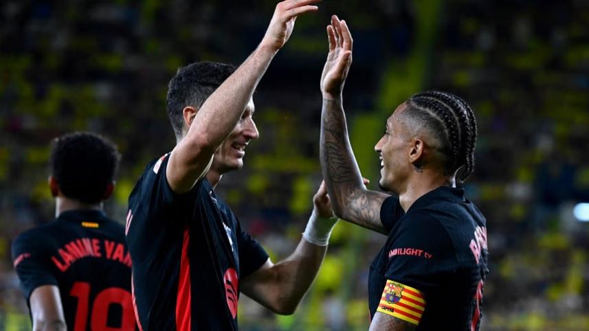 Barcelona's Raphinha celebrates with Robert Lewandowski