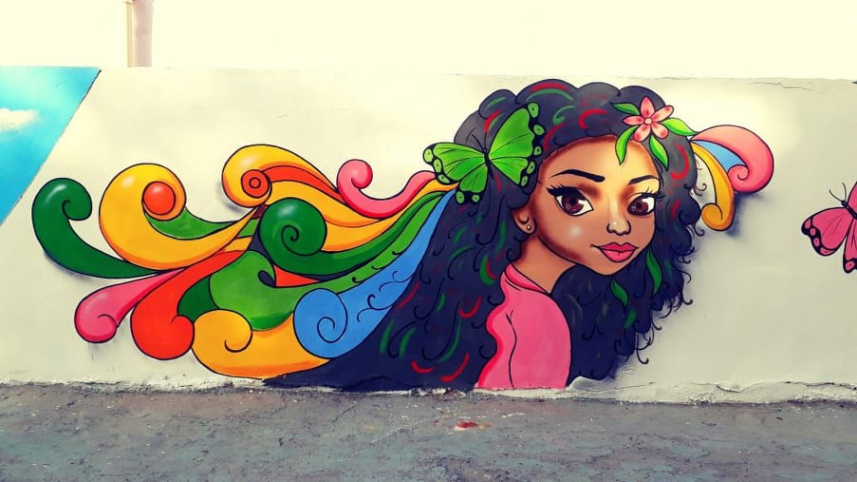 বাগদাদেদ দেওয়ালে আলি খলিফা  ও বাটারফ্লাই এফেক্টের আঁকা ম্যুরাল। ছবি: সংগৃহীত