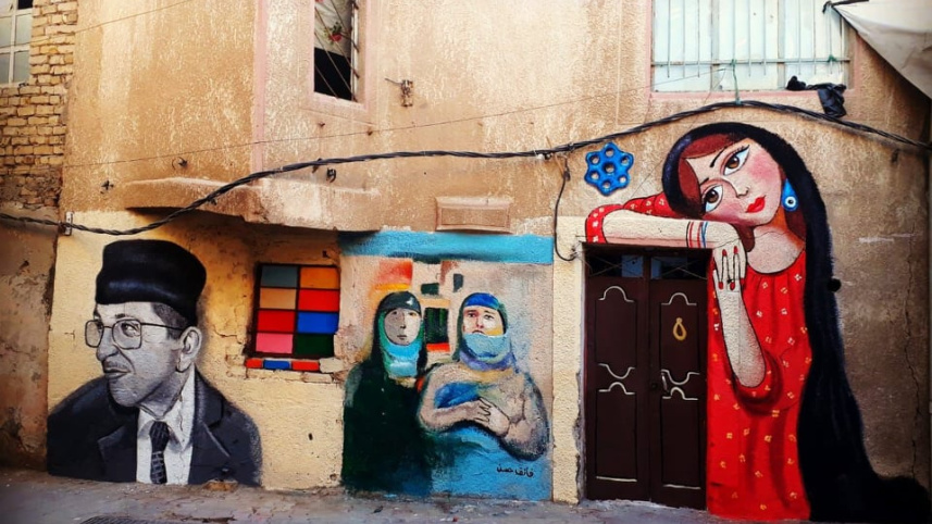 বাগদাদেদ দেওয়ালে আলি খলিফা  ও বাটারফ্লাই এফেক্টের আঁকা ম্যুরাল। ছবি: সংগৃহীত