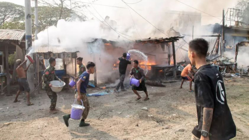 বিমান হামলার পর আগুন নেভানোর কাজ চলছে । ছবি: এএফপি