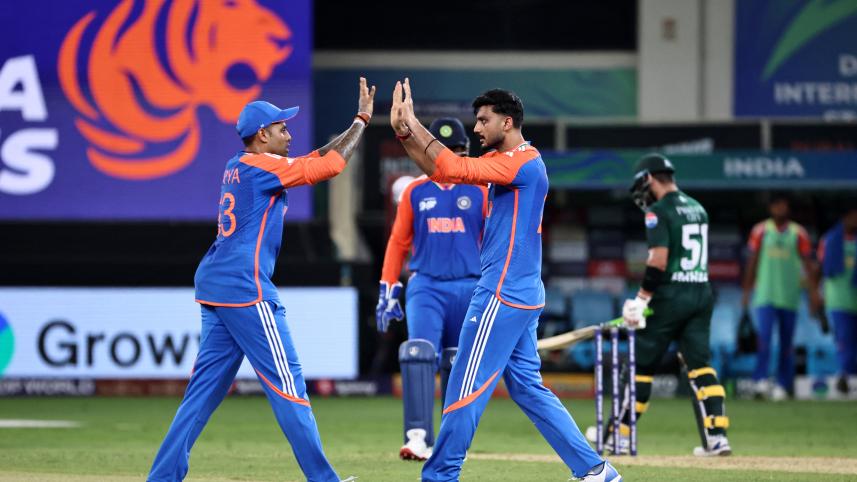 India's Axar Patel (R) celebrates with his captain Suryakumar Yadav after taking the wicket of Pakistan's captain Salman Agha 
