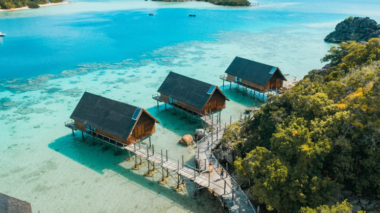 aerial-couple-walking-on-west-overwater-suites-pathway-with-lidi-view