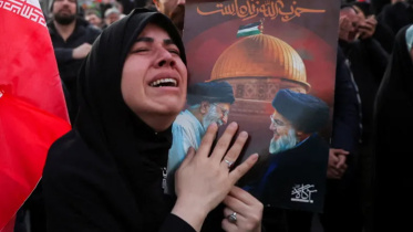 A woman reacts as people gather on Sunday at the Enghelab Square in the Iranian capital