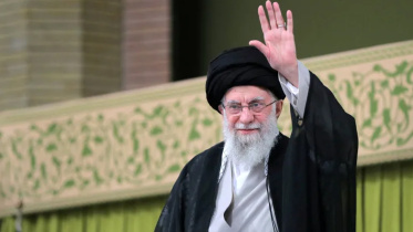 Khamenei waves during a meeting with students in Tehran