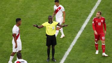 Referee Bakary Gassama calls for VAR (Video Assistant Referee) review 