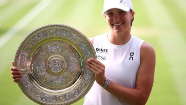 Poland's Iga Swiatek celebrates with the winner's trophy, the Venus Rosewater Dish, after winning against US player Amanda Anisimova 