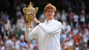 Italy's Jannik Sinner celebrates with the winner's trophy