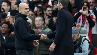 Manchester City's Spanish manager Pep Guardiola (L) shakes hands with Manchester United's English Interim head coach Michael Carrick (R)