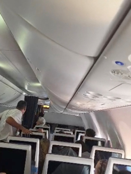 Flydubai passengers react after realising there is commotion in the cockpit, September 30, 2026 in this screengrab taken from a handout video