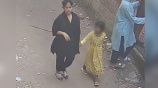  শিশু নুসরাতের হাত ধরে নিয়ে যাচ্ছেন এক তরুণী। ছবি: ভিডিও থেকে নেওয়া
